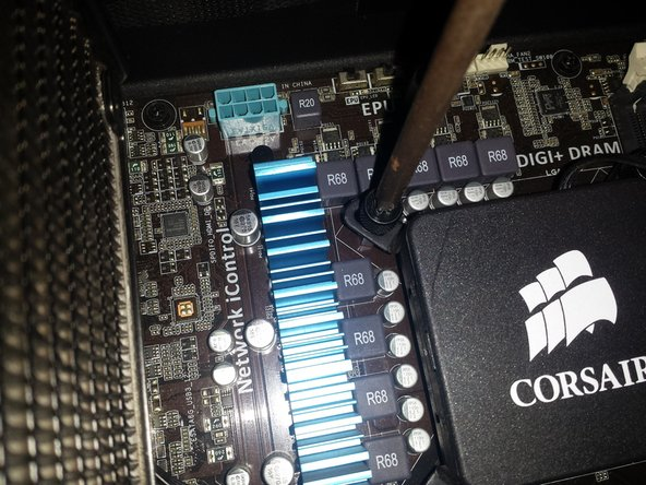 unscrewing the CPU fan for replacement