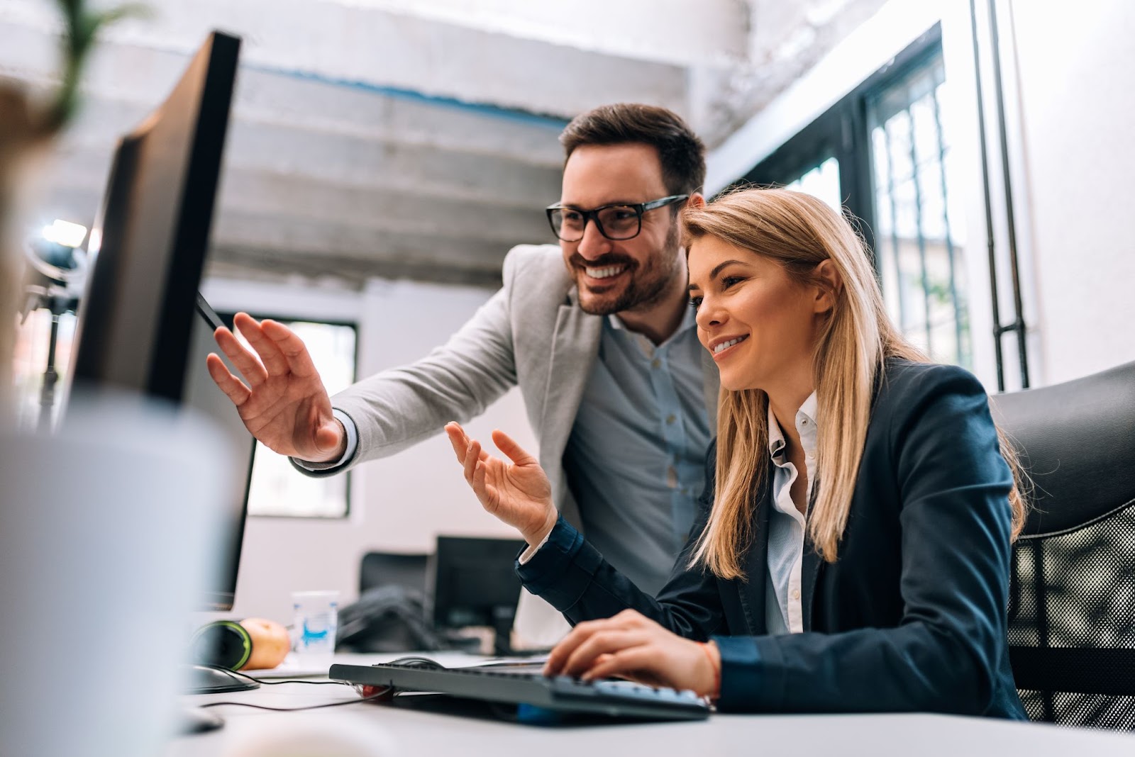 Coworkers looking at computer screen together