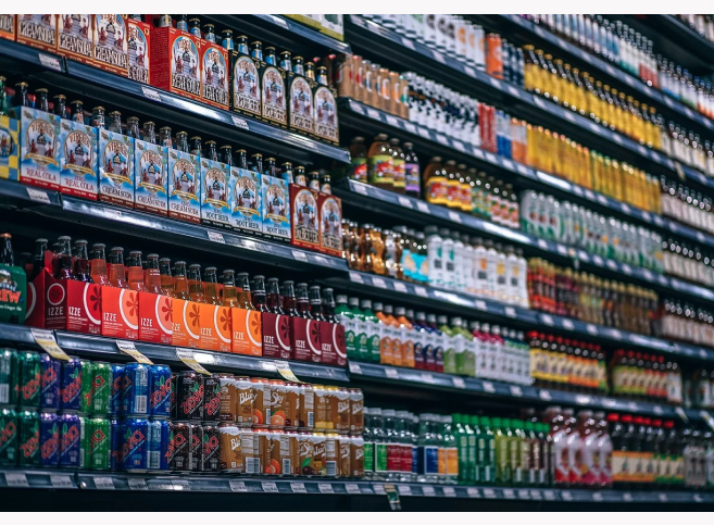 Supermarket shelves full of beverages, an example of CPG goods.