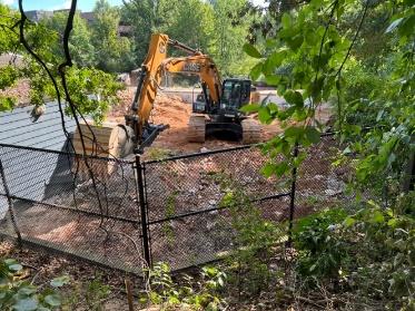 A bulldozer in a garden

Description automatically generated with medium confidence