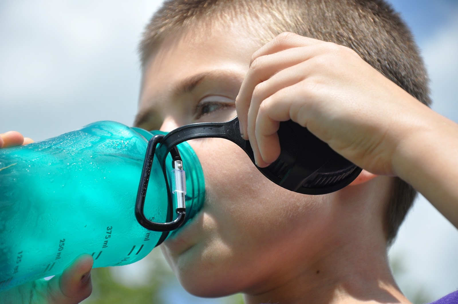 Kid drinking from water bottle