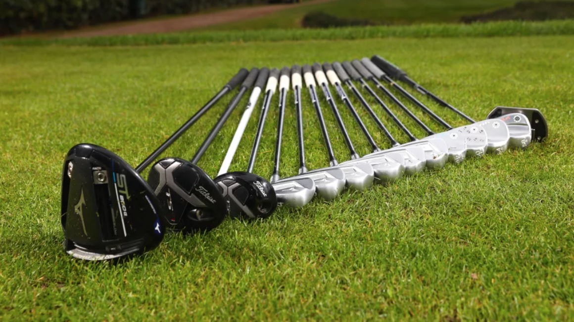 Set of golf clubs in grass