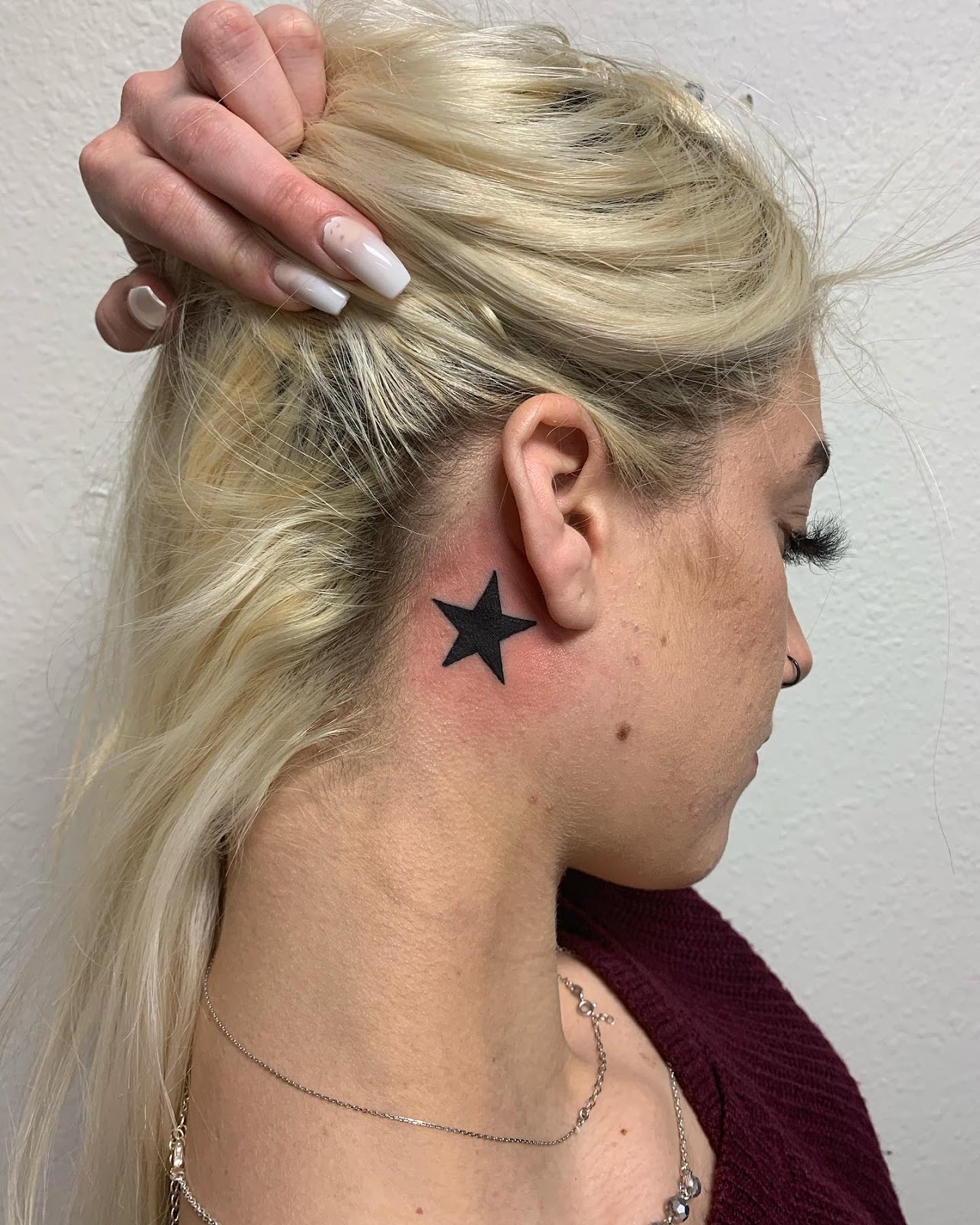 Bold Black Star Behind The Ear Tattoo