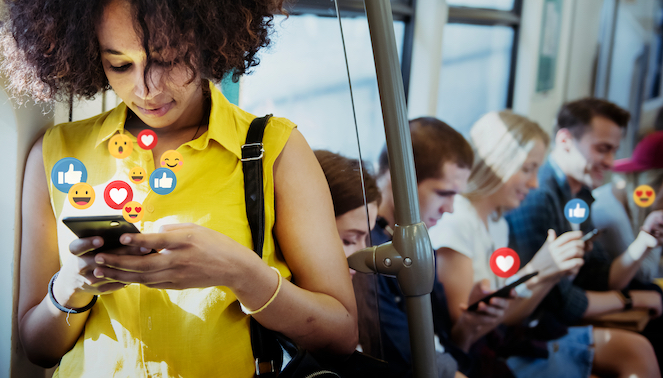 Young female in yellow shirt and black purse watching live stream on mobile phone