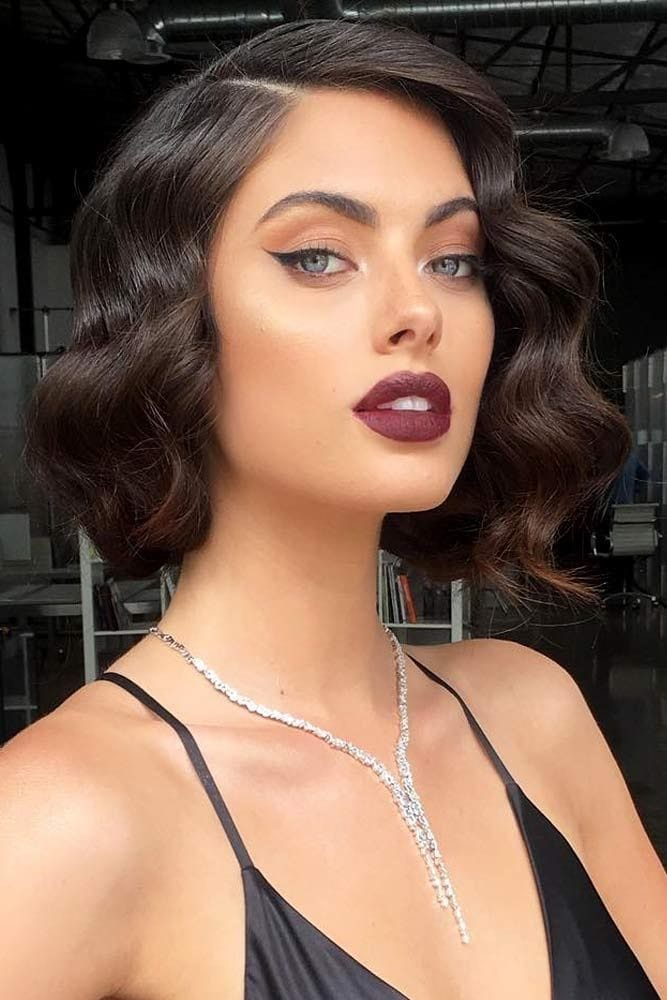 a brunette lady rocking waves for short hair with a beautiful necklace