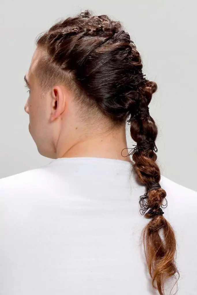 Back view of a guy rocking the stylish braids coiffure