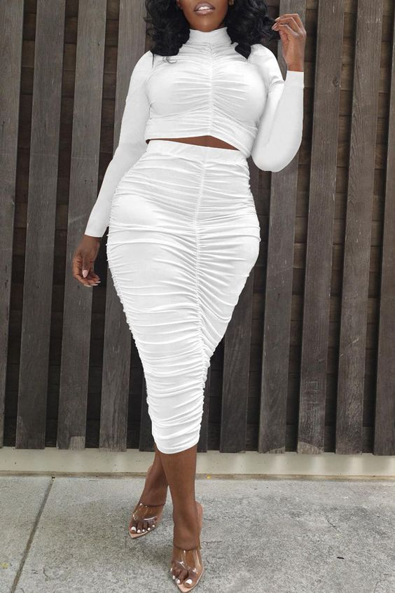 Woman wearing a pencil skirt and white two-piece outfit