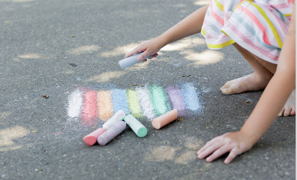Preschool child drawing with chalk