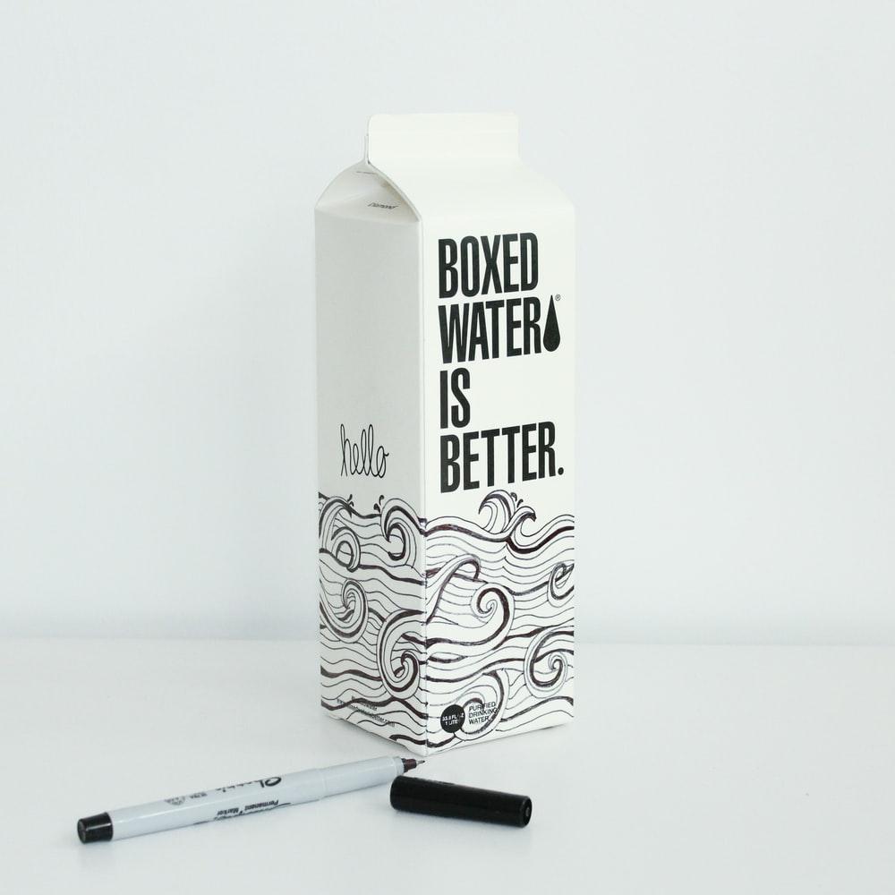 Boxed water is Better carton with waves drawn on it with a sharpie
