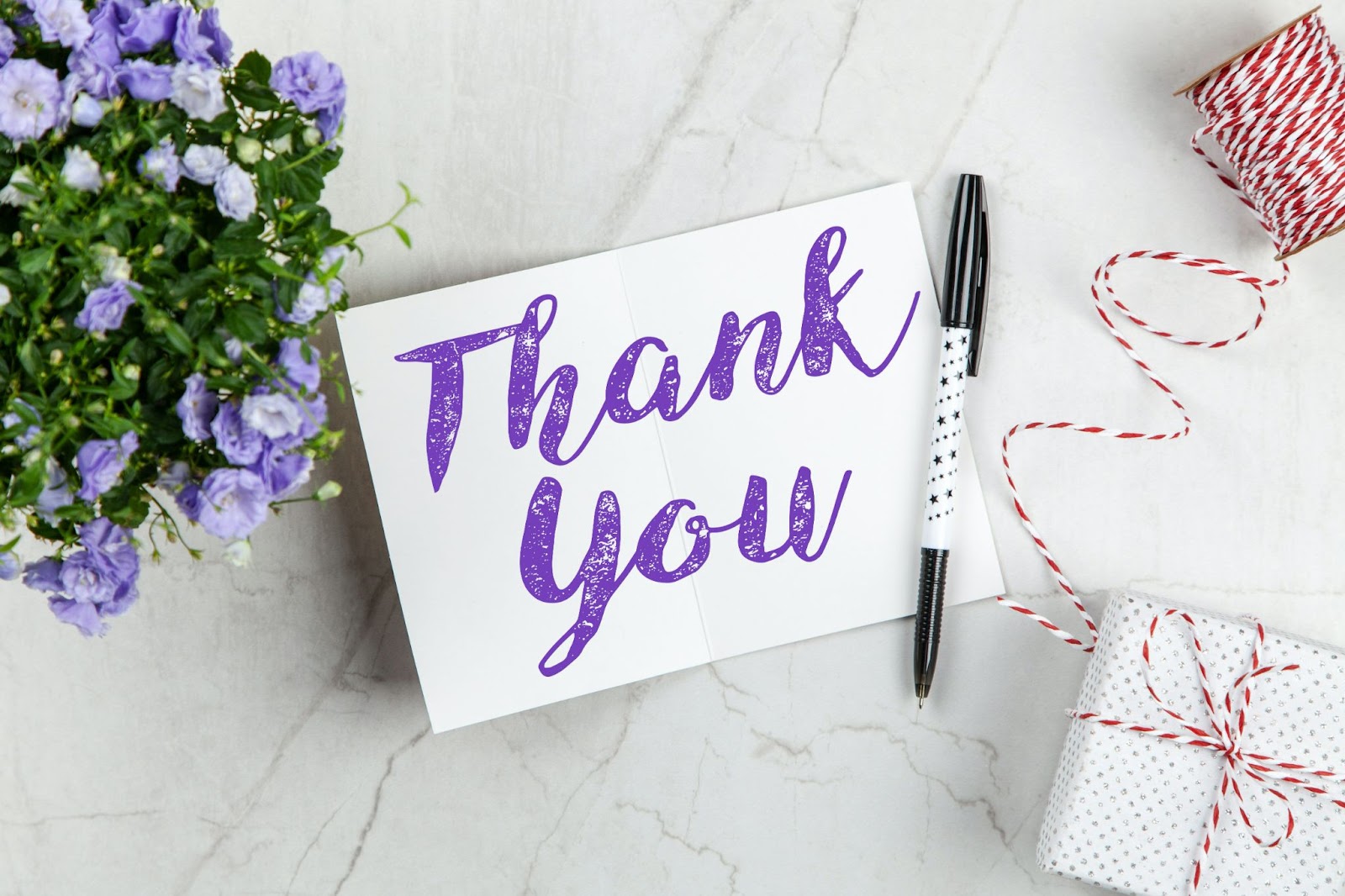 A Thank You Note Along With Flowers And Gift