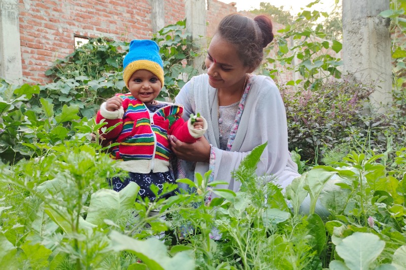 A mother and child enjoying time in a communcal garden