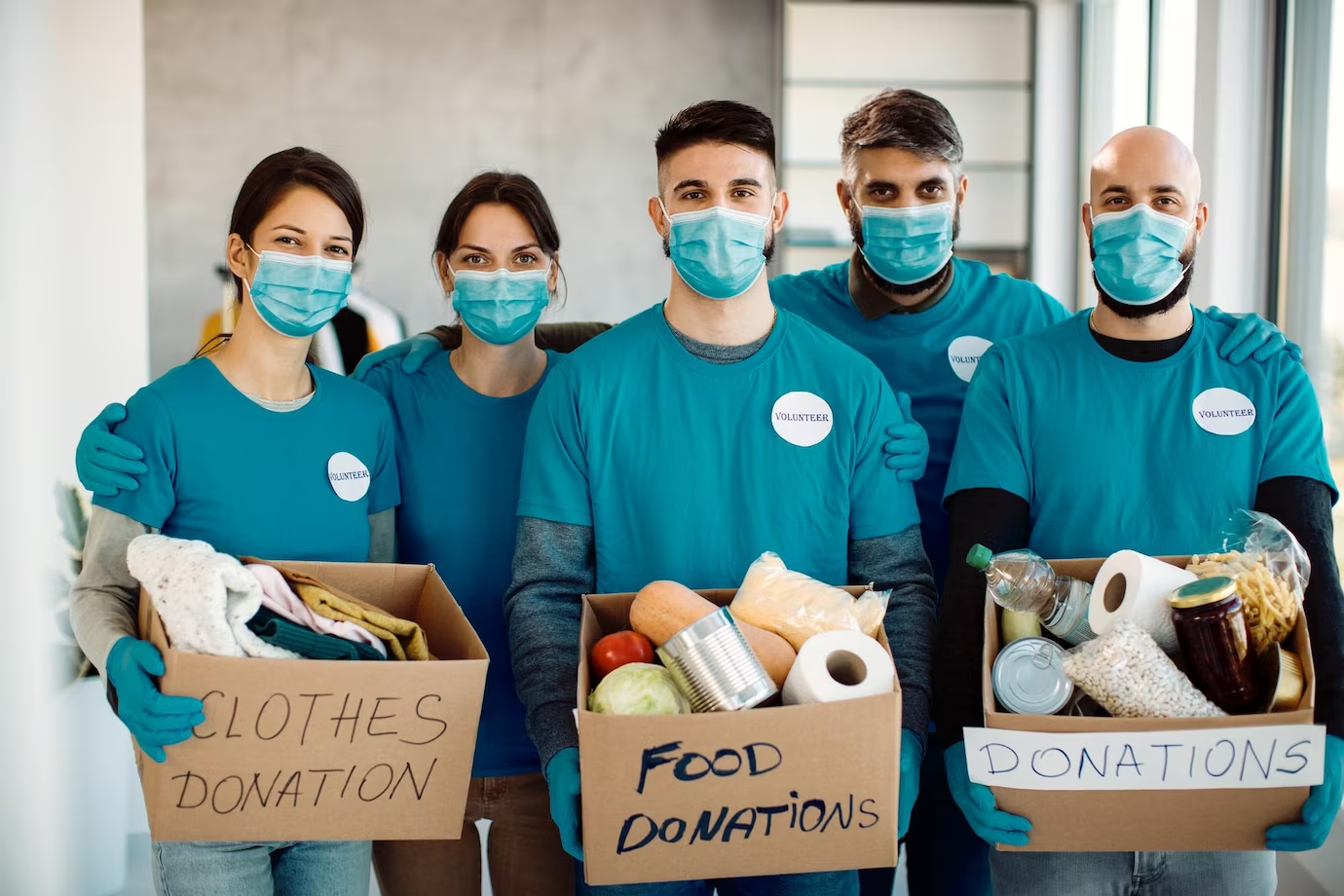 team of volunteers holding donation boxes