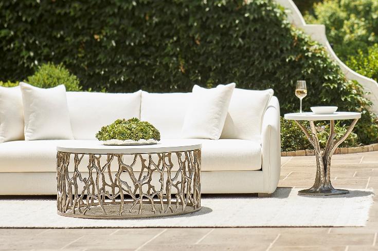 A white couch and a table outside

Description automatically generated