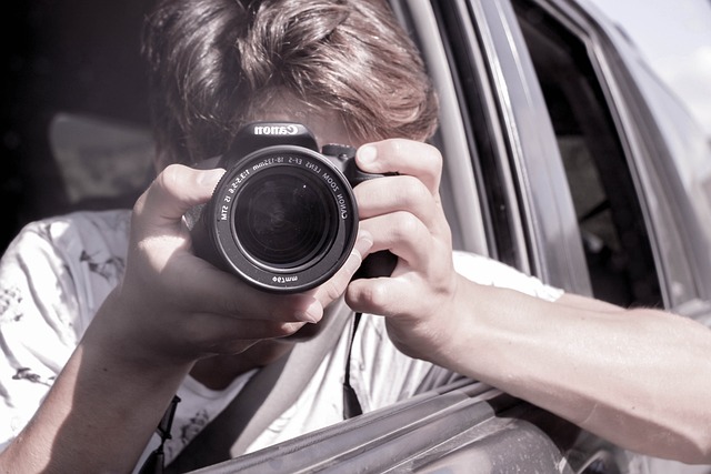 a teenager taking pictures in the car - things to do on a car trip with a teenager