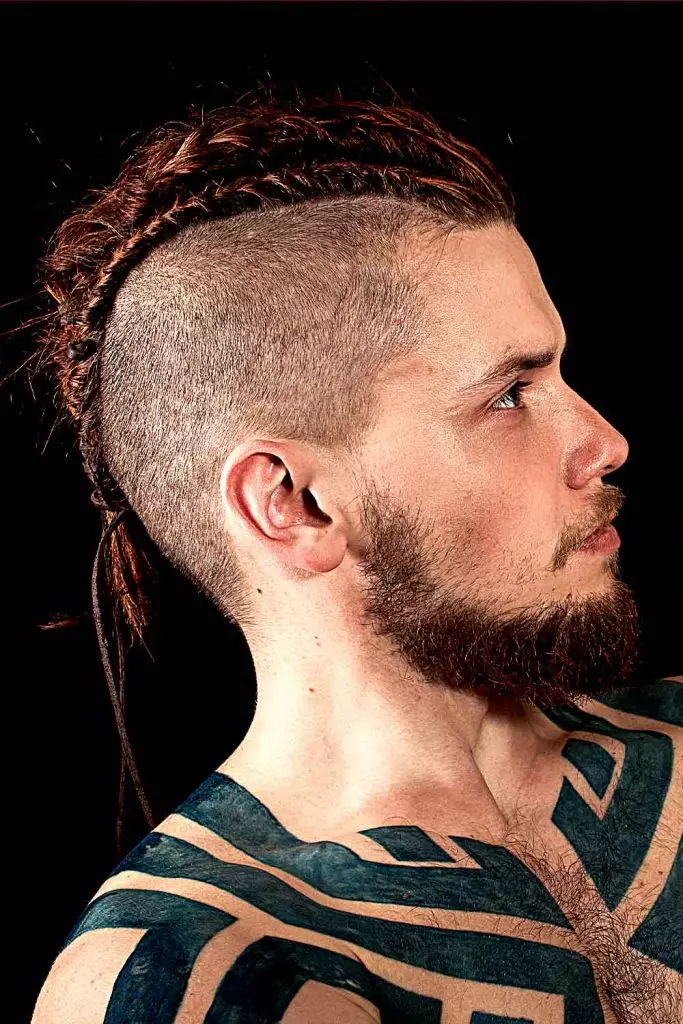 Side picture of a guy rocking the Viking braids coiffure