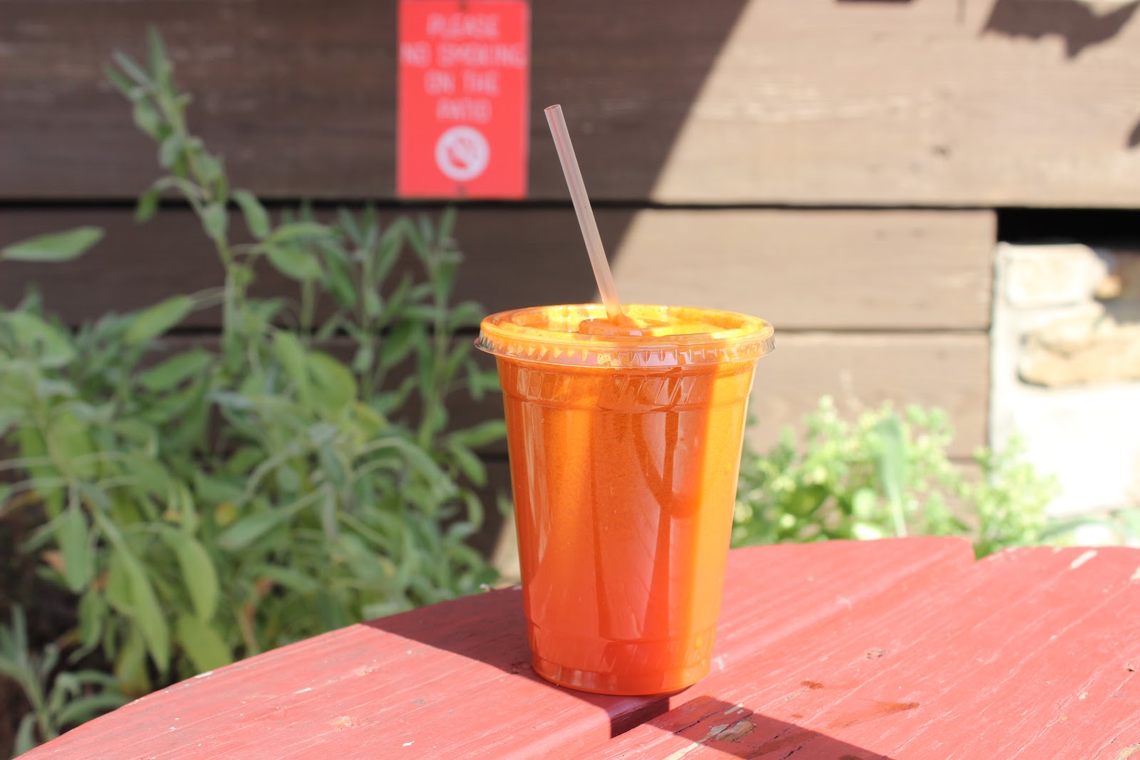 Orange juice outiside on table with sunshine