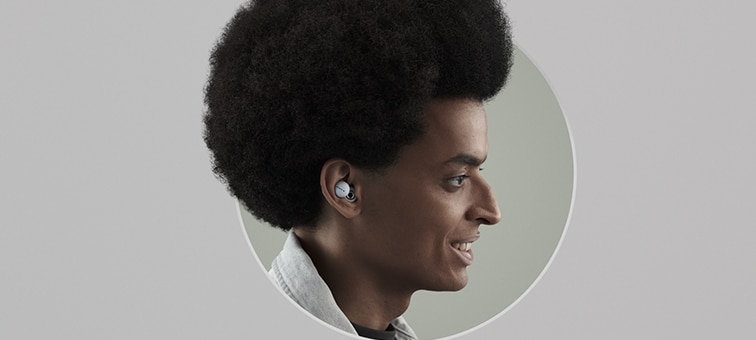 Side view of a man listening to white LinkBuds