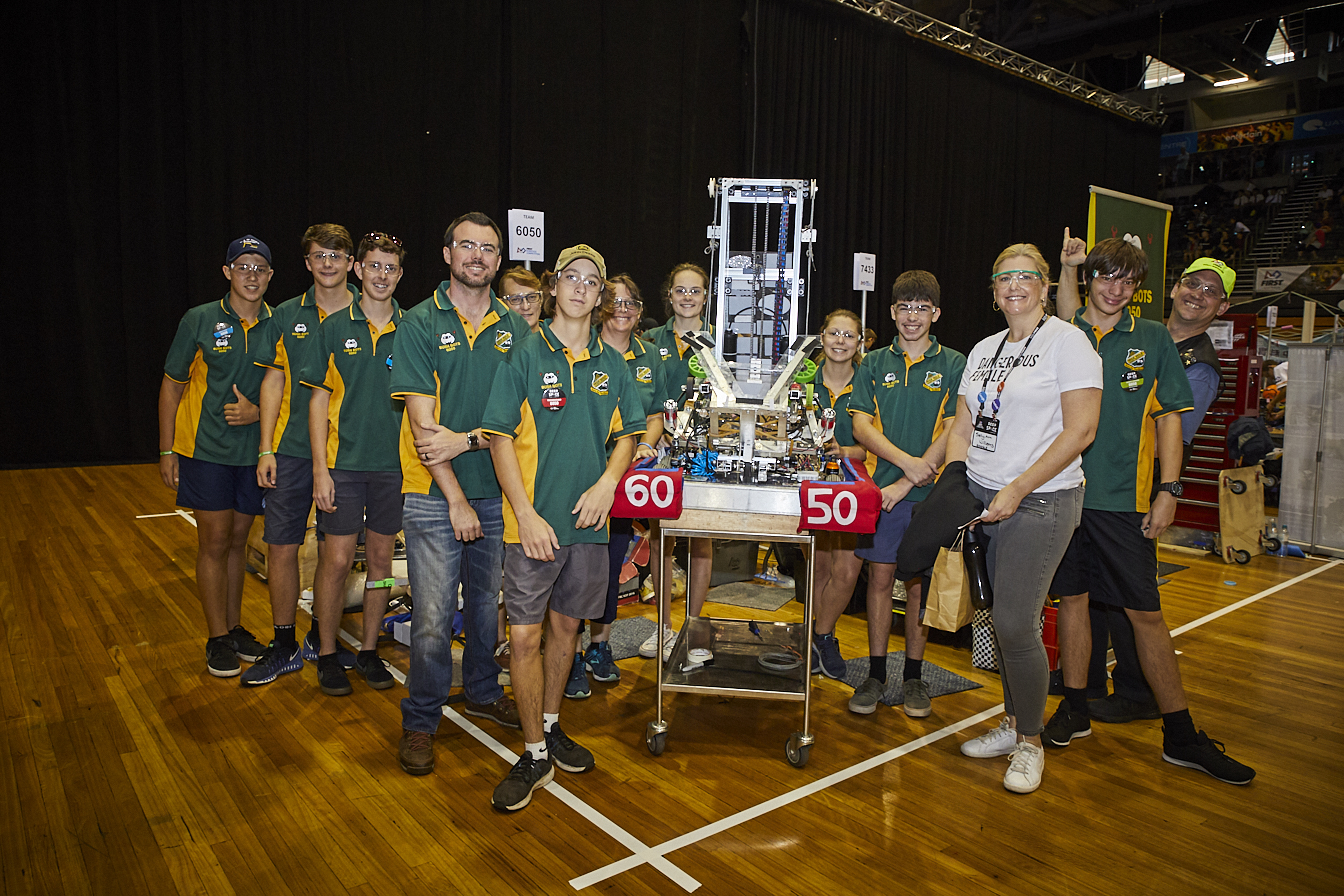 Photo of students with a large contraption at the FIRST Regional Robotics Competition at Sydney Olympic Park