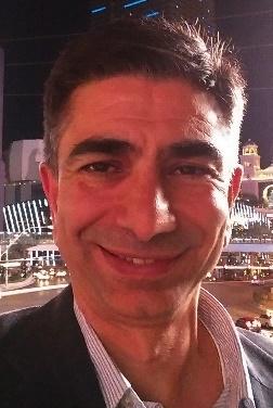 A close up of a person smiling for the camera Description automatically generated