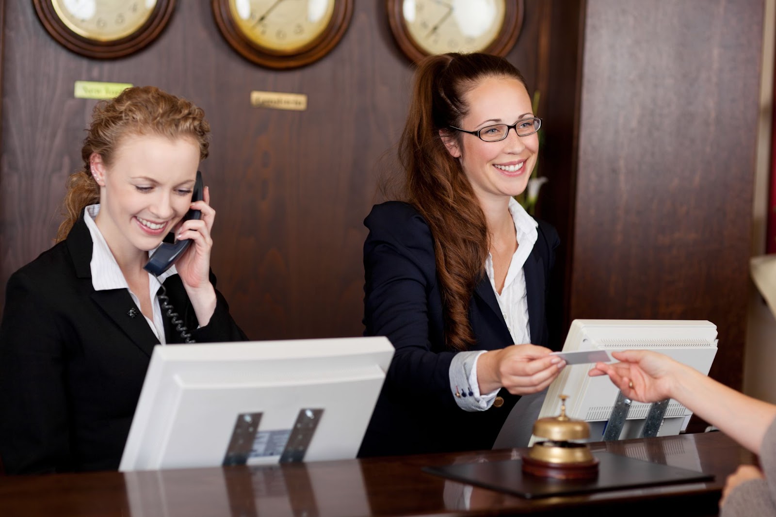 Two customer service representatives work behind a desk