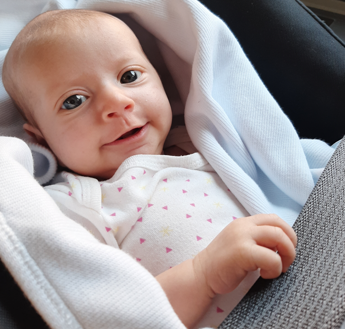 A baby in a car seat

Description automatically generated with medium confidence