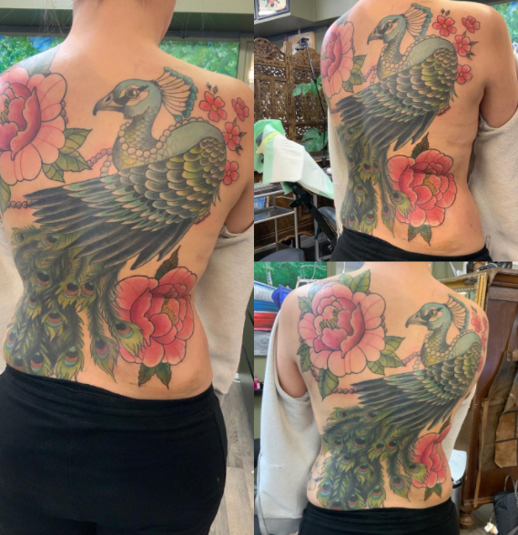 Adorable Peacock Tattoo Art On The Back 