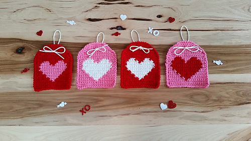 four heart tags on wooden table