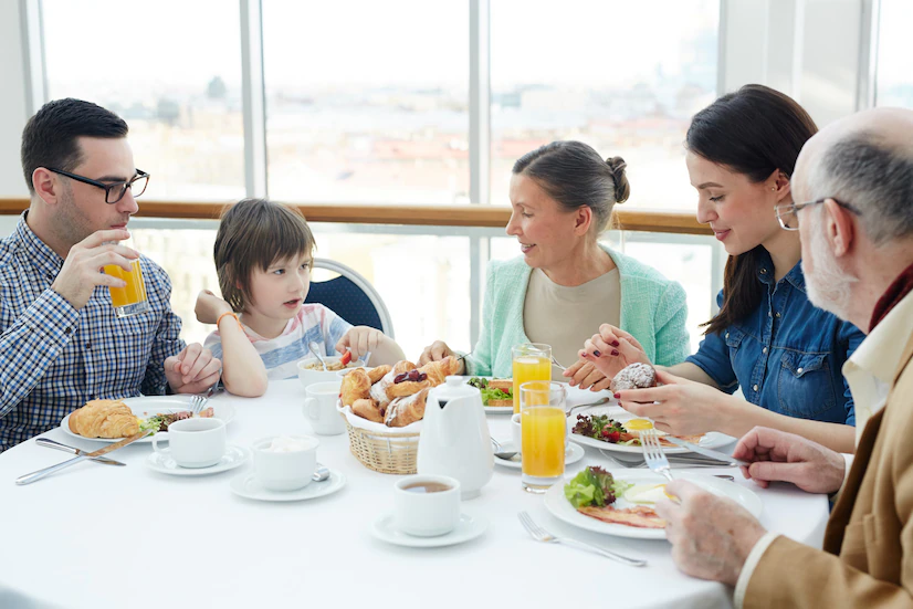 A picture containing person, table, indoor, sitting

Description automatically generated