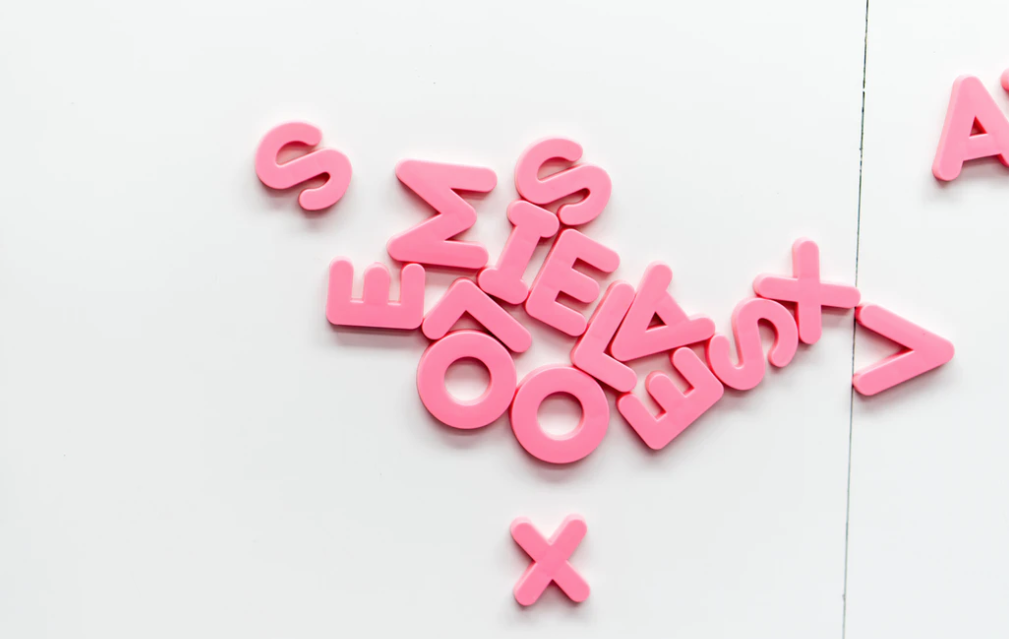 Various pink letters that are scrambled on a white background. If you want to learn how to build brand awareness for your blog, then keep reading.