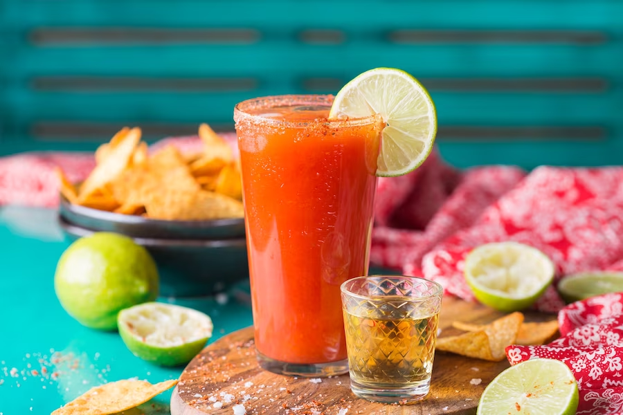 Tequila with fruit slices and chips on the side
