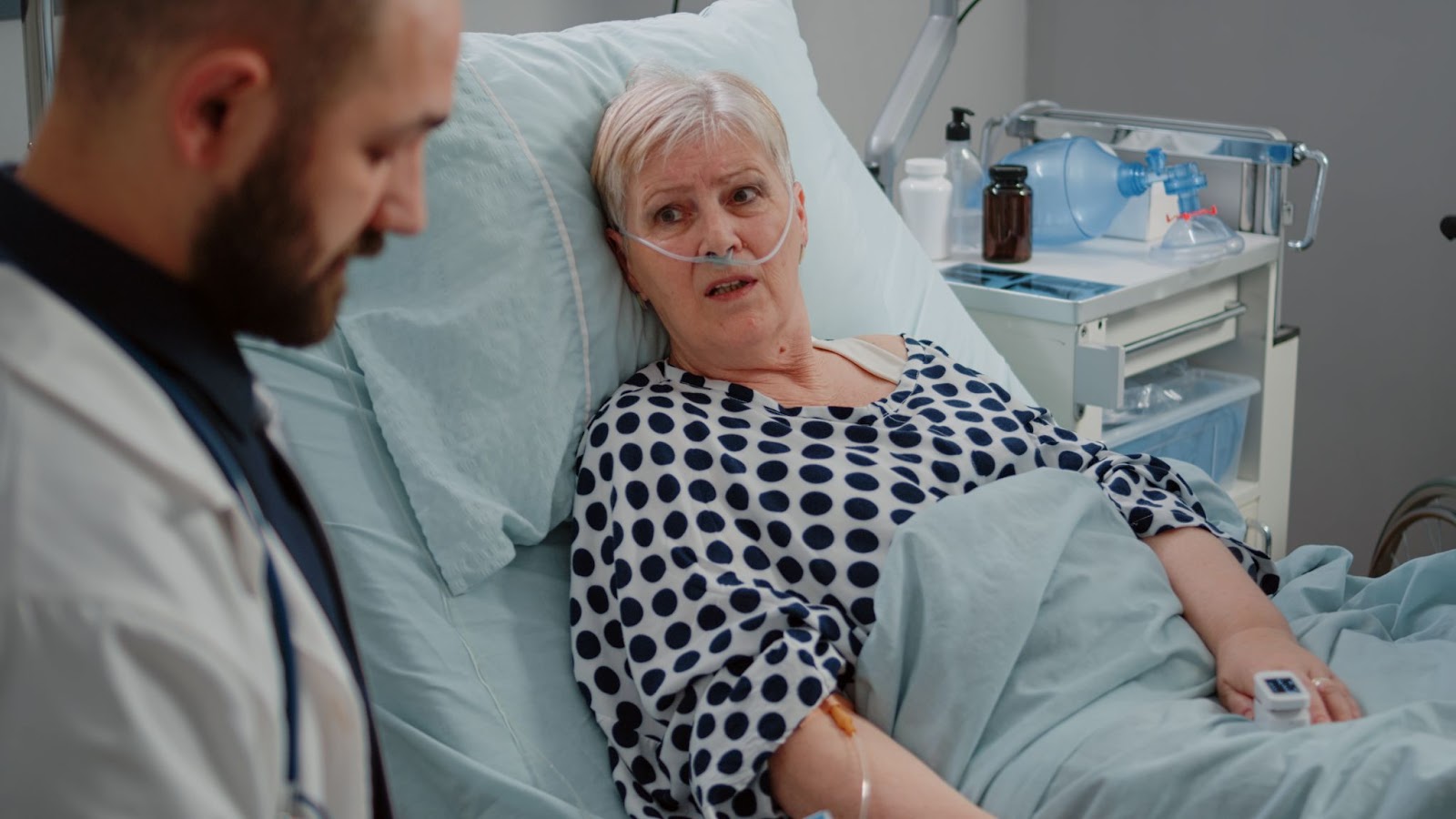 A nurse reading a page to a patient