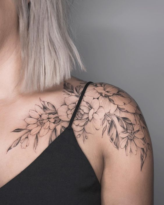 lady wearing flower tattoo on her shoulder to chest