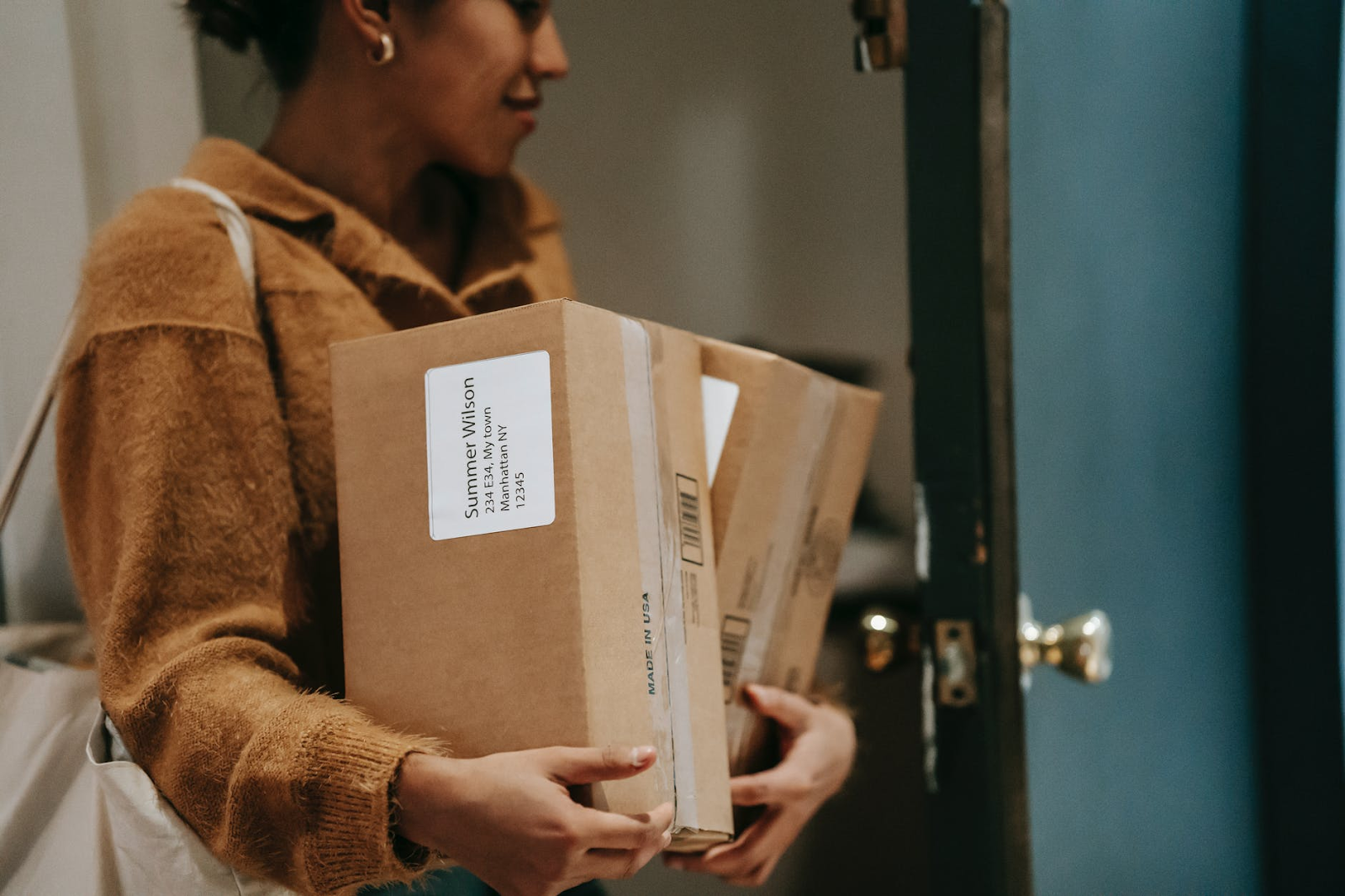 woman bringing in packages to her apartment 