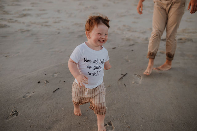 Young boy smiling at his parent's wedding proposal