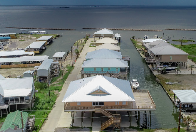 Colorful, tin-roofed homes on stilts, built right on the coast in Grand Isle, Louisiana. 