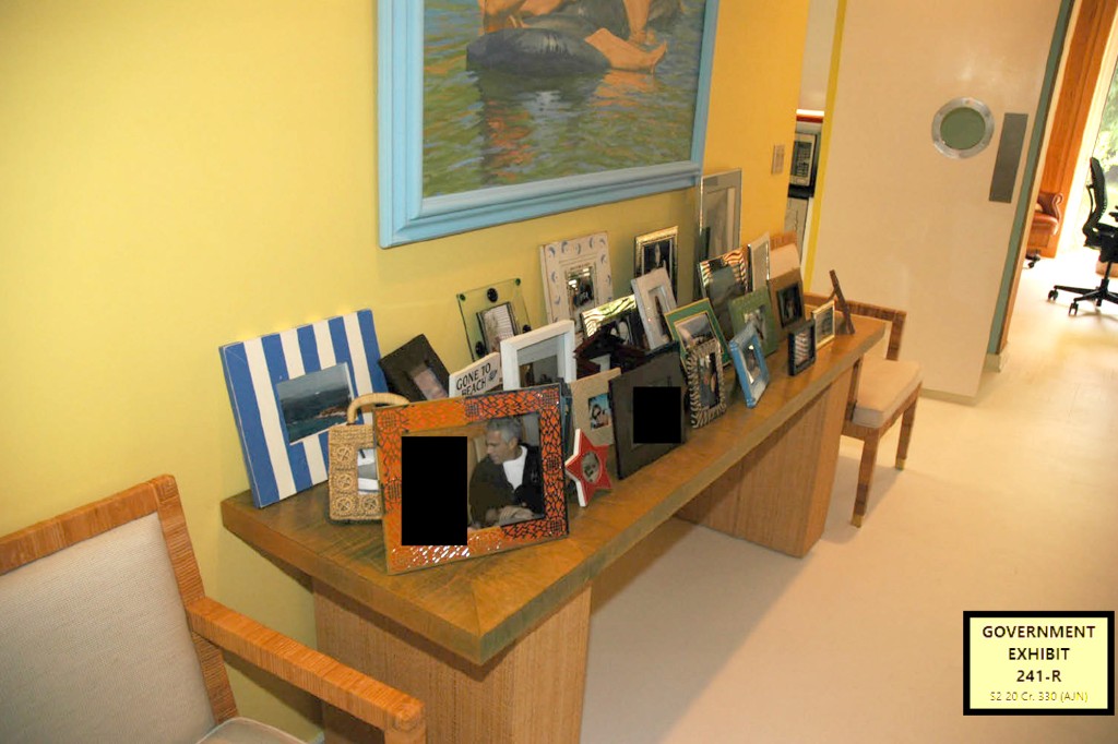 A table of photos at Epstein's Palm Beach manse.