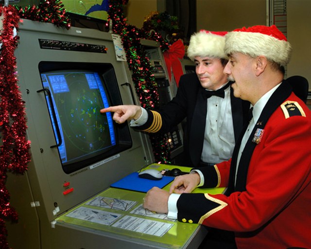 NORAD workers dressing in Santa hats on Christmas Eve. Image courtesy Wikimedia Commons.