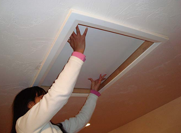 lady opening attic hatch