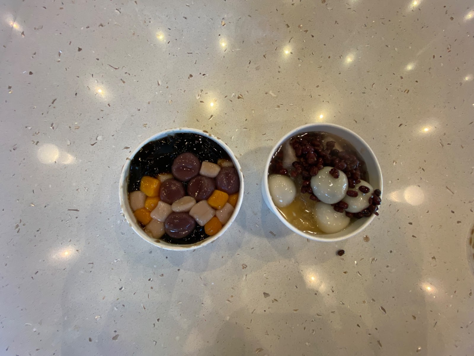 Left: Grass Jelly dessert with taro ball and taro rice ball toppings.
Right: Tofu pudding dessert with peanuts, sesame rice balls, red beans, and taro chunks.