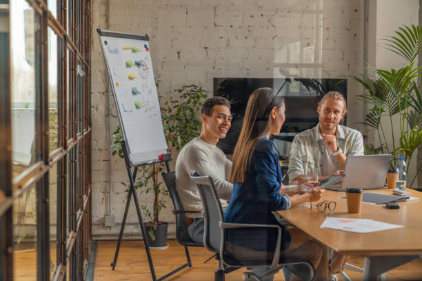 Indoor shot of creative team discussing ideas in business meeting. Multi ethnic business people working together on new project in office. Board Room, Meeting, Office, Working, Business Meeting brand design stock pictures, royalty-free photos & images