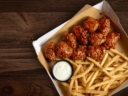 buffalo wings in a box with fries and ranch