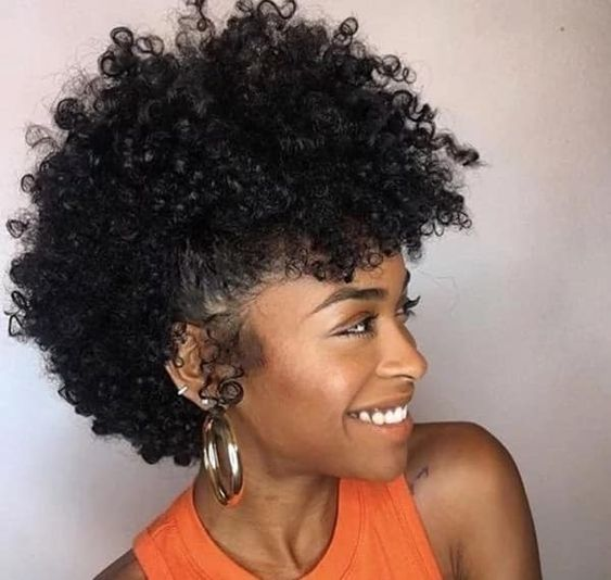 a naturalista smiling while wearing a frohawk