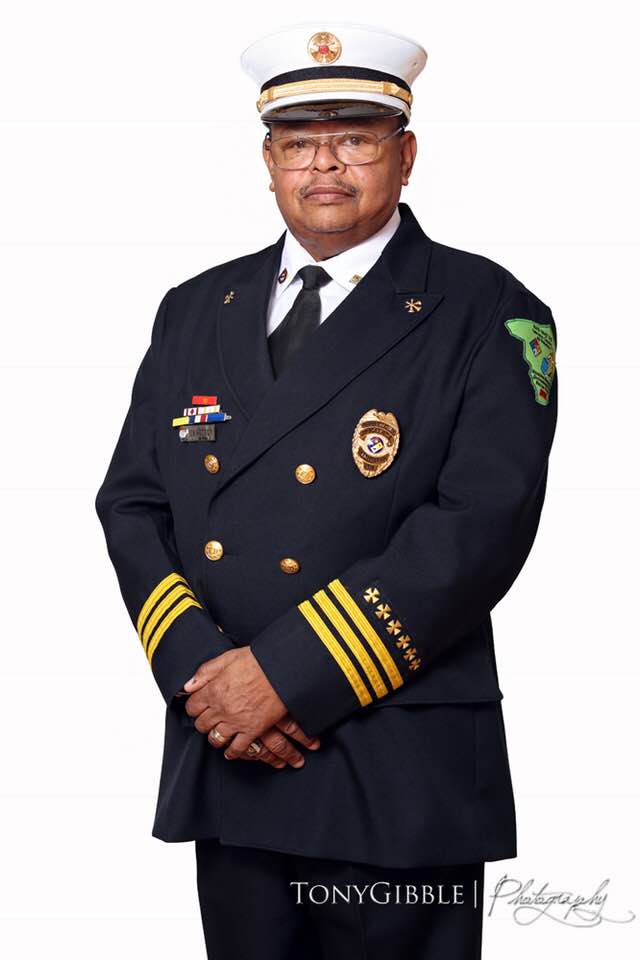 A firefighter posing in uniform