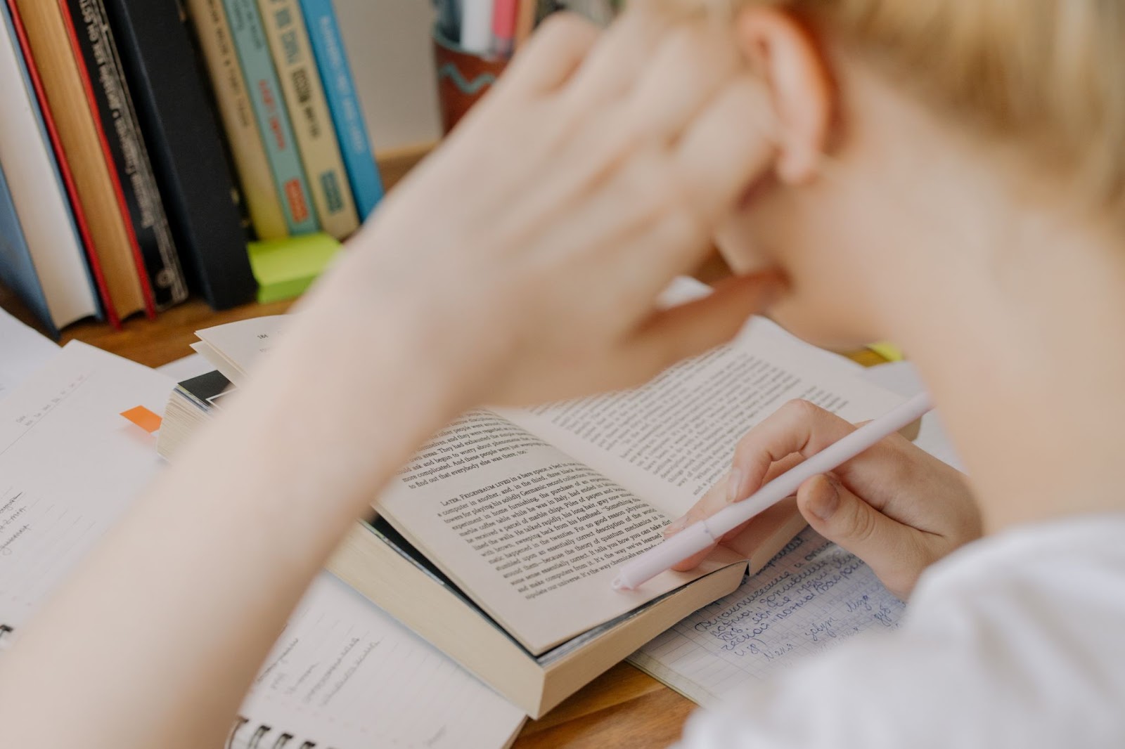 A person studying from a book. 