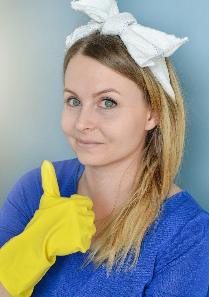 A cleaning lady giving a thumbs up.