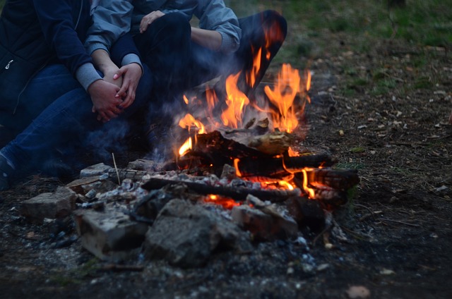 things to do while camping at night - cuddle by camfire with partner