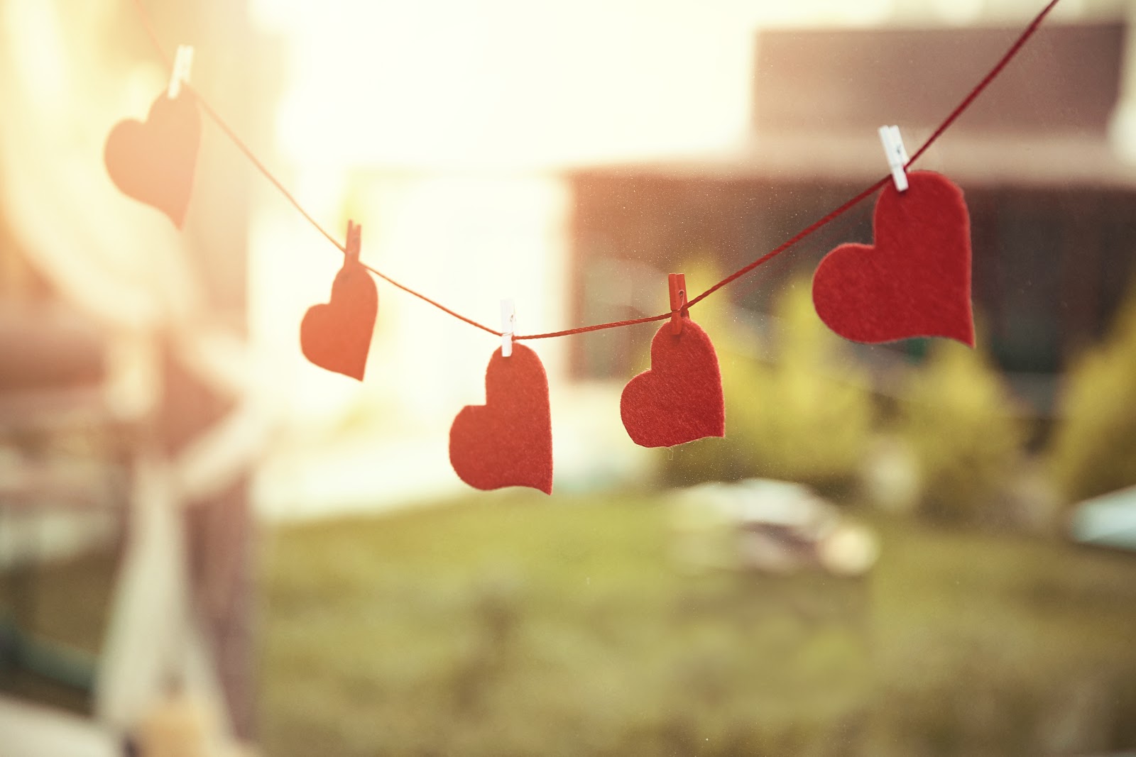 A row of red felt cloth hearts on a string