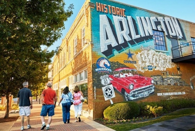 Locals walk past "Historic Arlington" mural in Texas