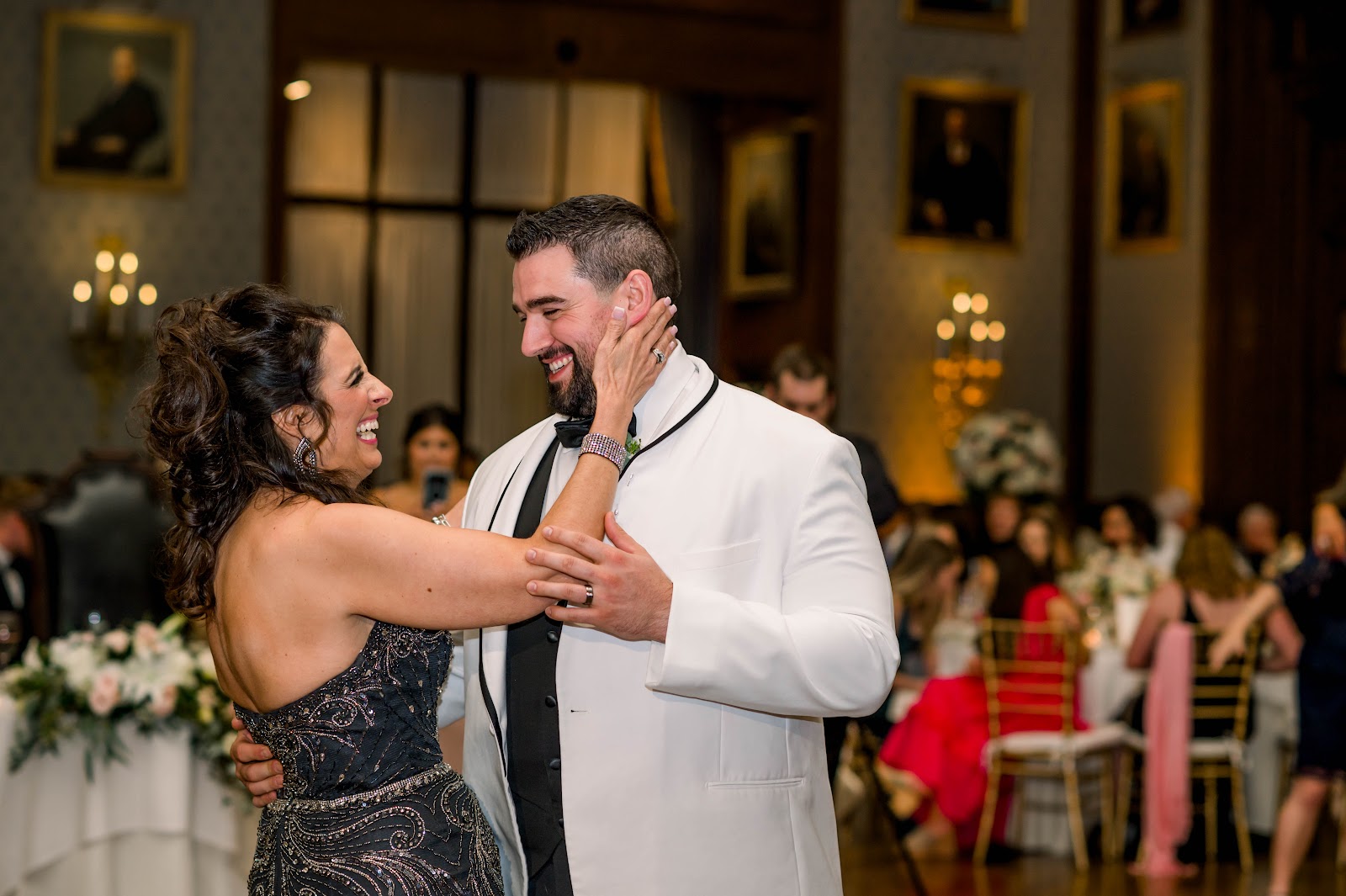 Documentary wedding photography demonstrated through a groom and mother of the groom enjoying their mother-son-dance.