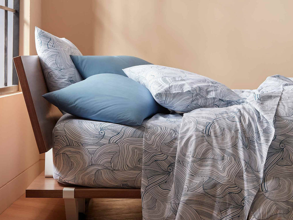 Bed with blue-and-white patterned sheets